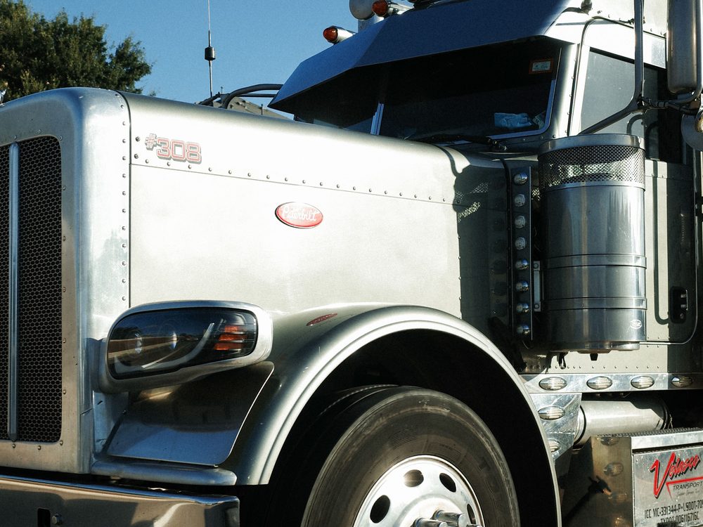 The chrome front end of a parked Peterbilt tractor unit